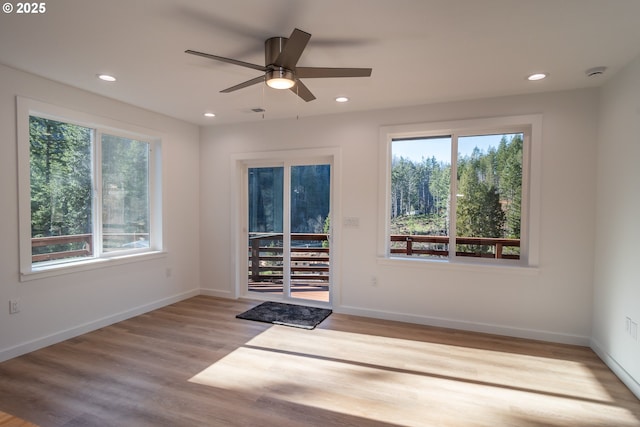 unfurnished room with visible vents, baseboards, ceiling fan, wood finished floors, and recessed lighting