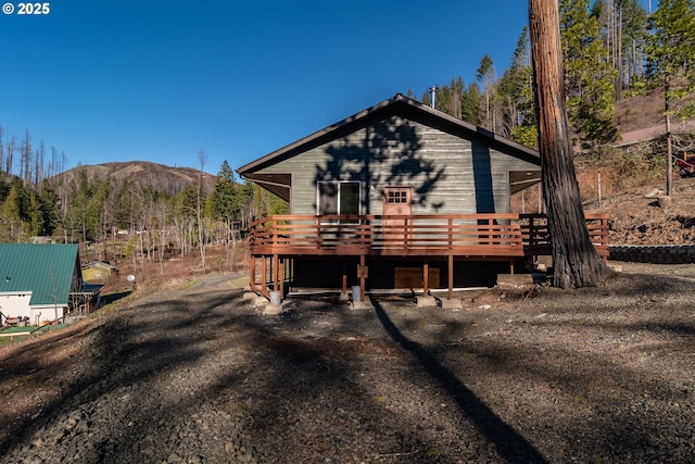 view of front of home with a deck with mountain view