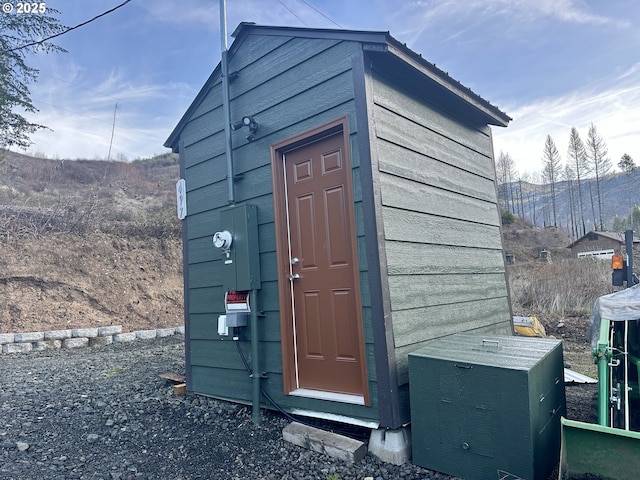 view of outbuilding with a mountain view and an outdoor structure