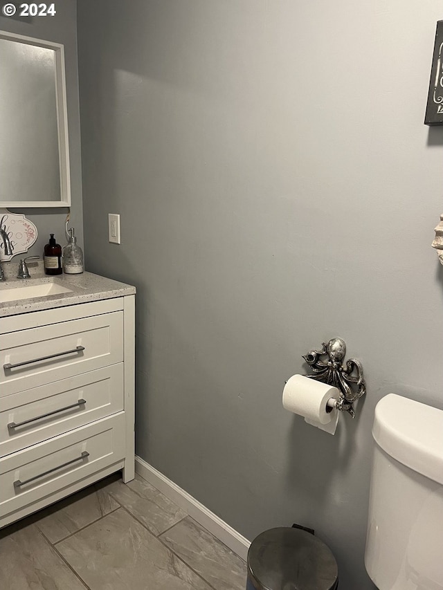 62760 Koski Rd, Coos Bay, OR 97420 - half bath with marble look tile flooring, toilet, vanity, and baseboards
