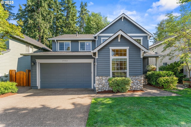 craftsman-style home featuring fence, an attached garage, a shingled roof, concrete driveway, and a front lawn