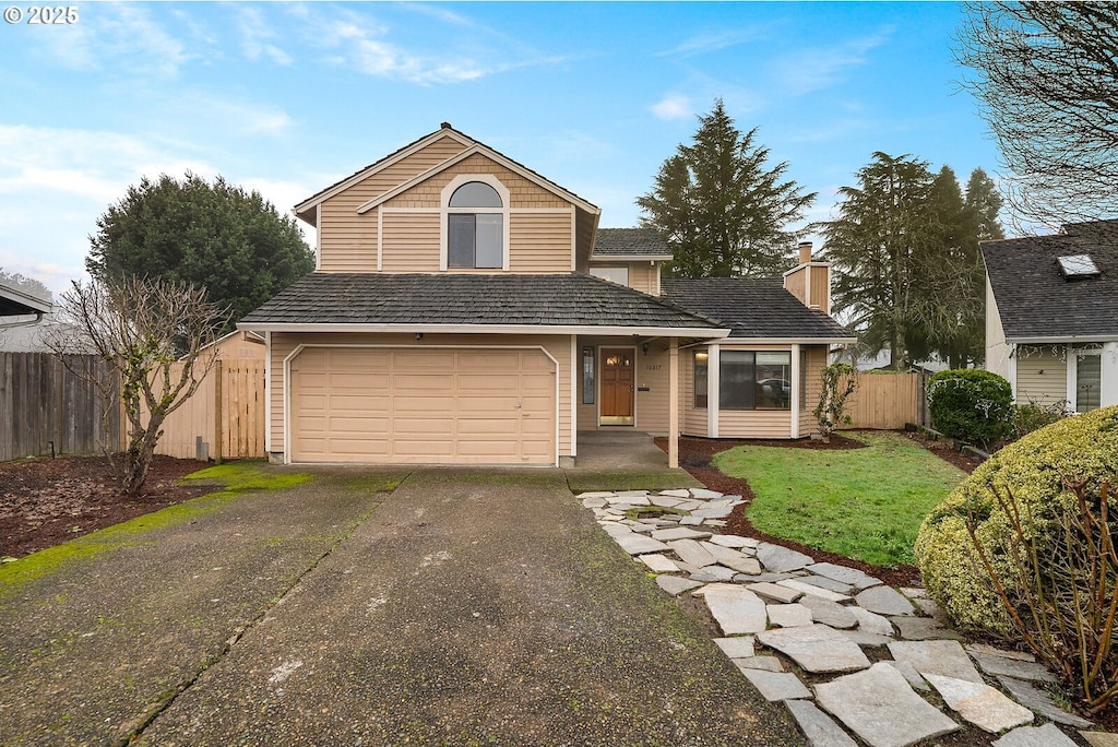 view of front property with a garage and a front lawn