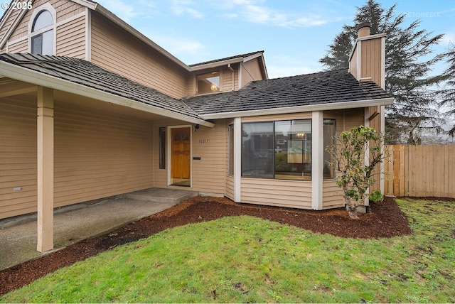 view of exterior entry featuring a yard