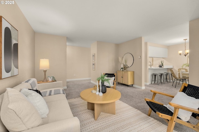 living room with light colored carpet and an inviting chandelier