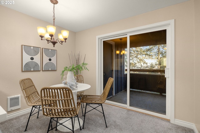 dining area featuring carpet floors, heating unit, and a notable chandelier