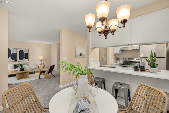 carpeted dining space with sink and a notable chandelier