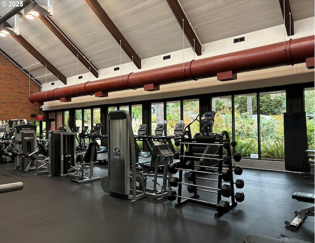 exercise room featuring brick wall, high vaulted ceiling, and wooden ceiling