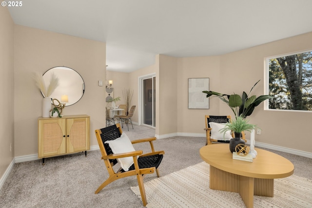 sitting room featuring light colored carpet