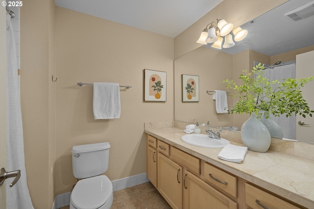 1500 SW Park Ave Unit 429, Portland, OR 97201 - bathroom with vanity, toilet, tile patterned flooring, a chandelier, and baseboards