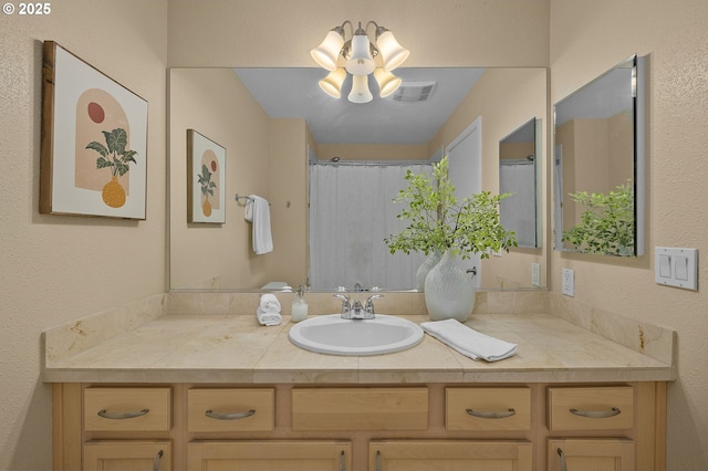1500 SW Park Ave Unit 429, Portland, OR 97201 - bathroom featuring vanity, a textured wall, and a shower with shower curtain