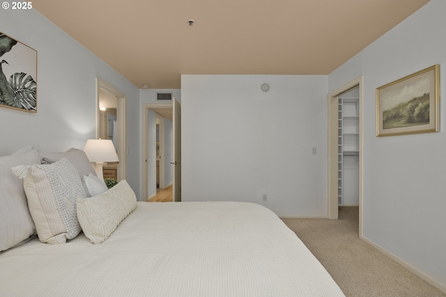 1500 SW Park Ave Unit 429, Portland, OR 97201 - carpeted bedroom with a walk in closet, a closet, and baseboards
