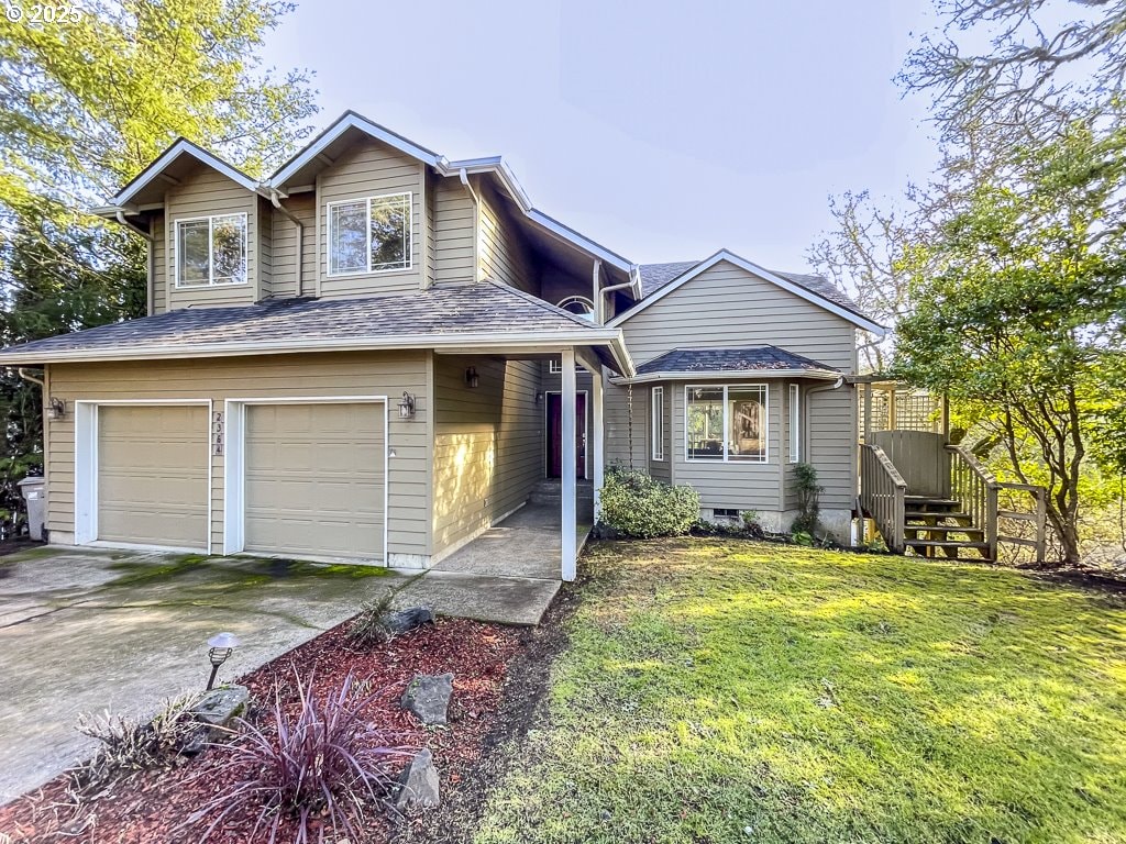 view of front of home with a garage and a front lawn