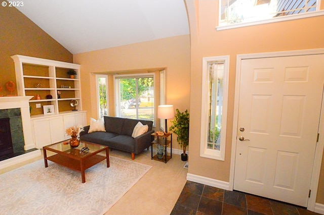 foyer with a fireplace and vaulted ceiling