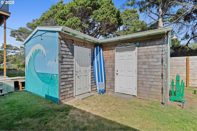 view of outbuilding with a yard