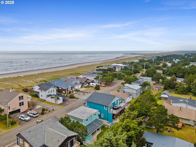 bird's eye view with a water view and a beach view