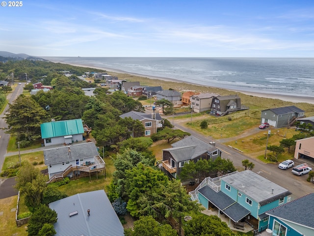 birds eye view of property featuring a water view and a view of the beach