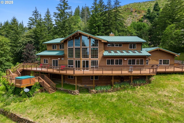 back of property featuring a yard and a deck with mountain view