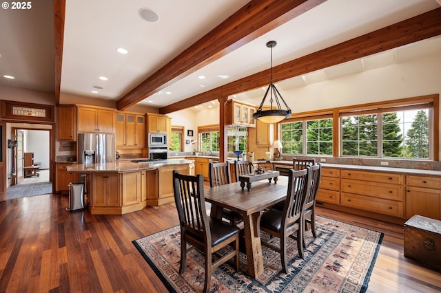 dining space featuring beam ceiling and dark hardwood / wood-style floors