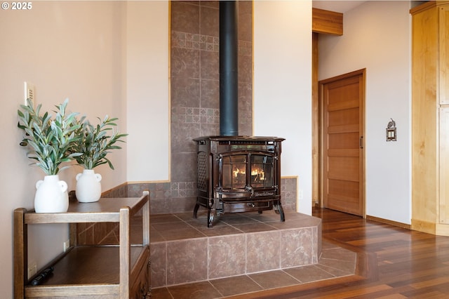 interior details featuring wood-type flooring and a wood stove