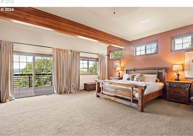 carpeted bedroom with access to exterior and beamed ceiling