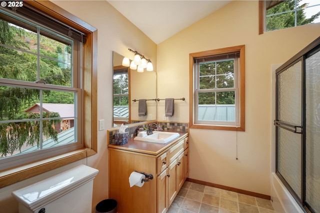 bathroom featuring lofted ceiling and vanity