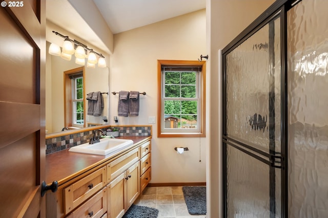 bathroom featuring walk in shower, vanity, lofted ceiling, and decorative backsplash