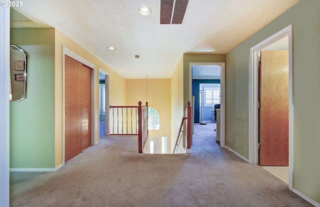 10535 SW 135th Ave, Beaverton, OR 97008 - hallway with an upstairs landing, carpet flooring, a textured ceiling, and recessed lighting