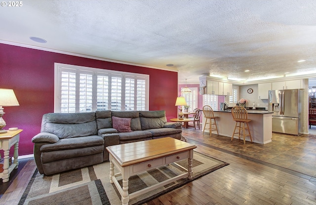 10535 SW 135th Ave, Beaverton, OR 97008 - living room featuring a textured ceiling, hardwood / wood-style flooring, and crown molding