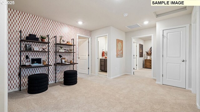 miscellaneous room featuring light colored carpet