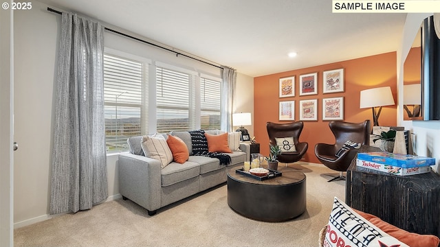 carpeted living area featuring baseboards