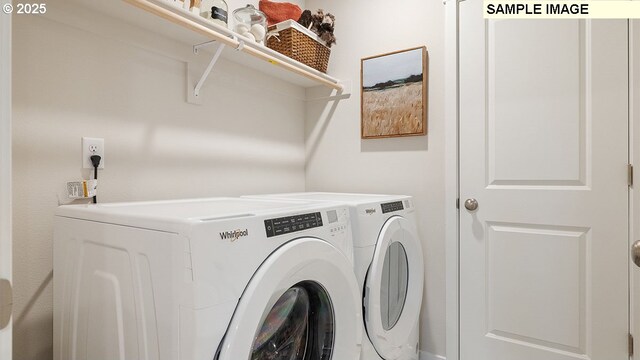 clothes washing area with washing machine and clothes dryer