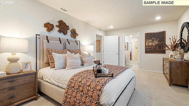 bedroom featuring visible vents, baseboards, light colored carpet, recessed lighting, and ensuite bathroom