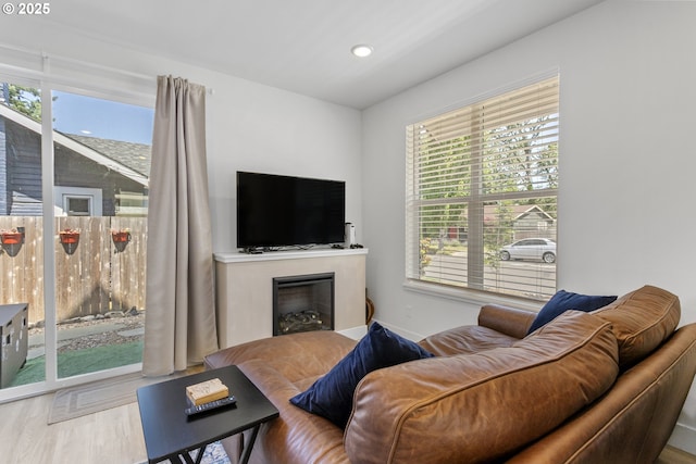 7557 N Gilbert Ave, Portland, OR 97203 - living room with plenty of natural light, wood finished floors, a fireplace, and recessed lighting