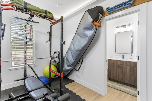 7557 N Gilbert Ave, Portland, OR 97203 - exercise room featuring a sink and light wood-style floors