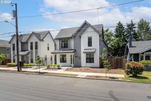 7557 N Gilbert Ave, Portland, OR 97203 - view of front of property with board and batten siding, a standing seam roof, a metal roof, and roof with shingles