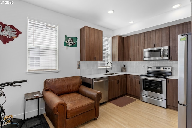 7557 N Gilbert Ave, Portland, OR 97203 - kitchen featuring appliances with stainless steel finishes, light countertops, healthy amount of natural light, backsplash, and recessed lighting