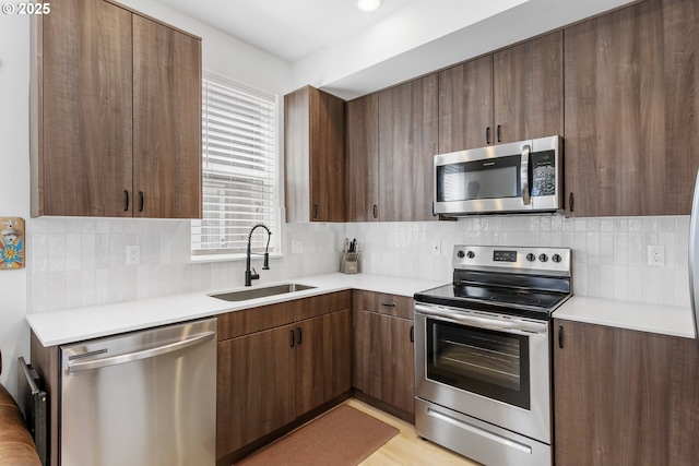 7557 N Gilbert Ave, Portland, OR 97203 - kitchen with stainless steel appliances, light countertops, and tasteful backsplash