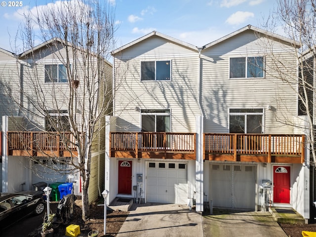 view of front of house featuring a garage, a wooden deck, and a balcony