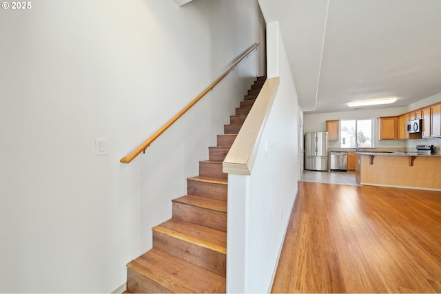 stairs with hardwood / wood-style floors