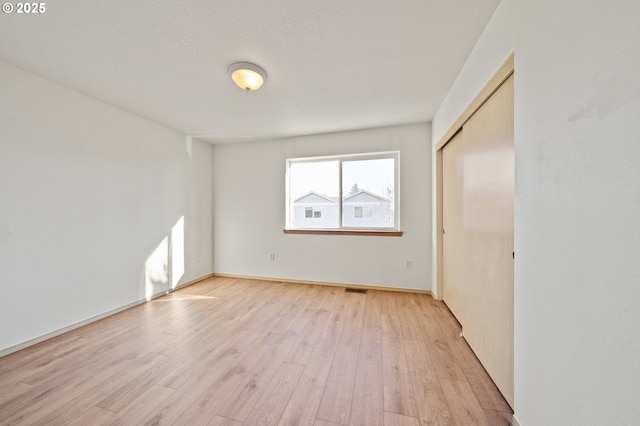 unfurnished room with light hardwood / wood-style floors