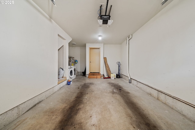 garage featuring a garage door opener and washer / dryer