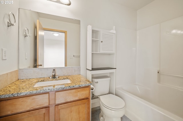 full bathroom featuring washtub / shower combination, vanity, and toilet