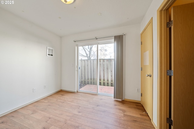 spare room featuring light hardwood / wood-style floors