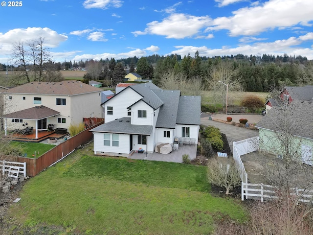 back of property with a yard and a patio area