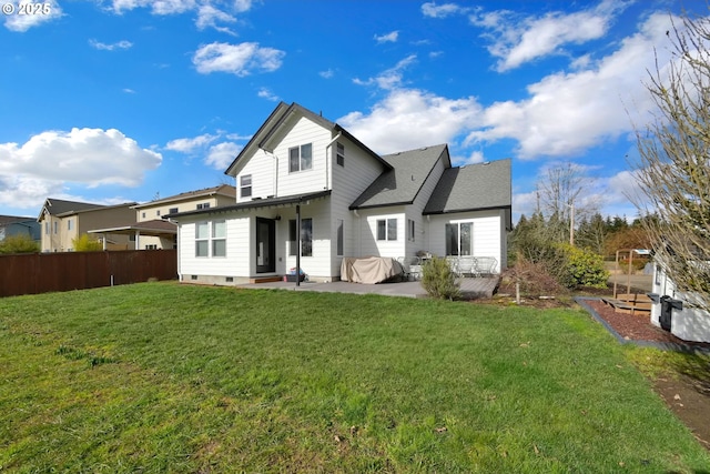 back of house featuring a lawn and a patio