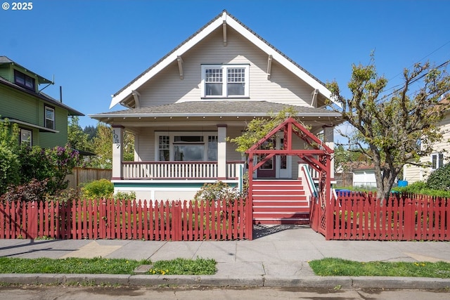 1037 SE 80th Ave, Portland, OR 97215 - view of front facade featuring a porch, a shingled roof, and a fenced front yard