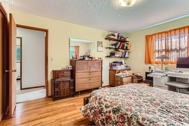 14385 SW Hargis Rd, Beaverton, OR 97008 - bedroom featuring light wood-style flooring, a textured ceiling, and a desk