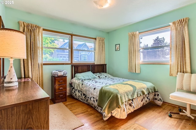 14385 SW Hargis Rd, Beaverton, OR 97008 - bedroom featuring wood finished floors and multiple windows