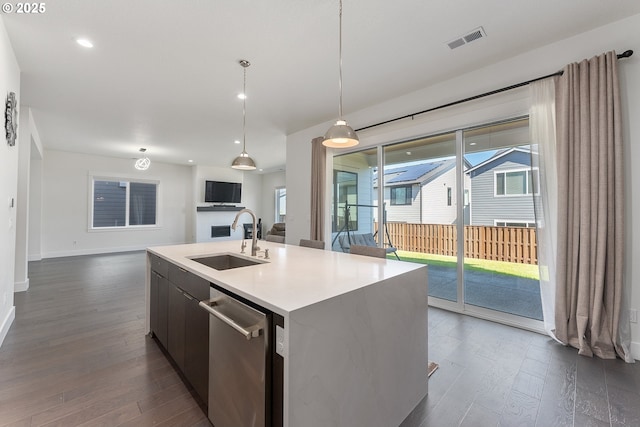 15875 NW Ridgeline St, Portland, OR 97229 - kitchen with stainless steel dishwasher, dark wood-style flooring, open floor plan, an island with sink, and recessed lighting