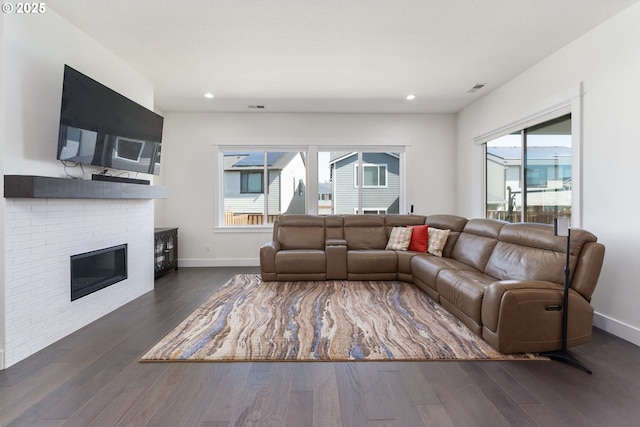 15875 NW Ridgeline St, Portland, OR 97229 - living area featuring dark wood-type flooring, a brick fireplace, and recessed lighting